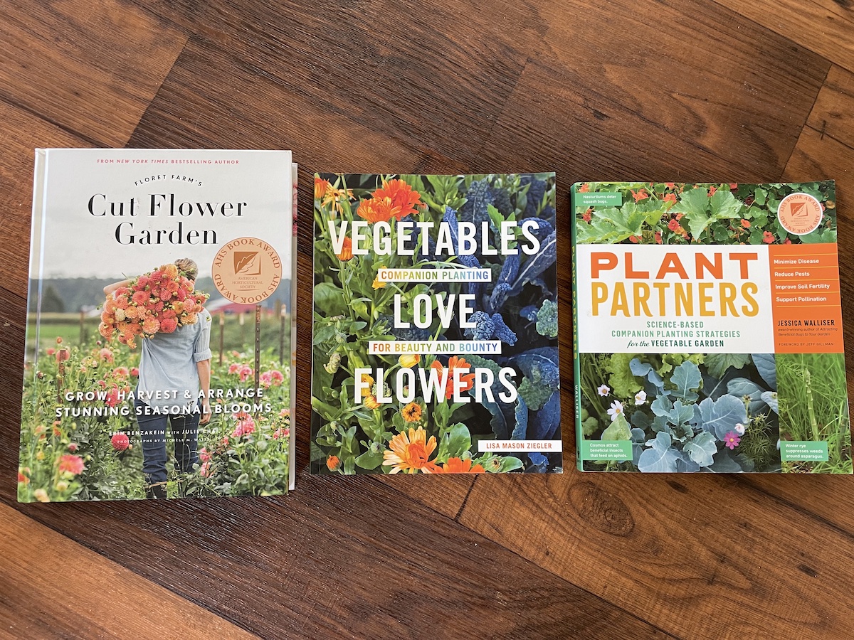 three flower gardening books side by side
